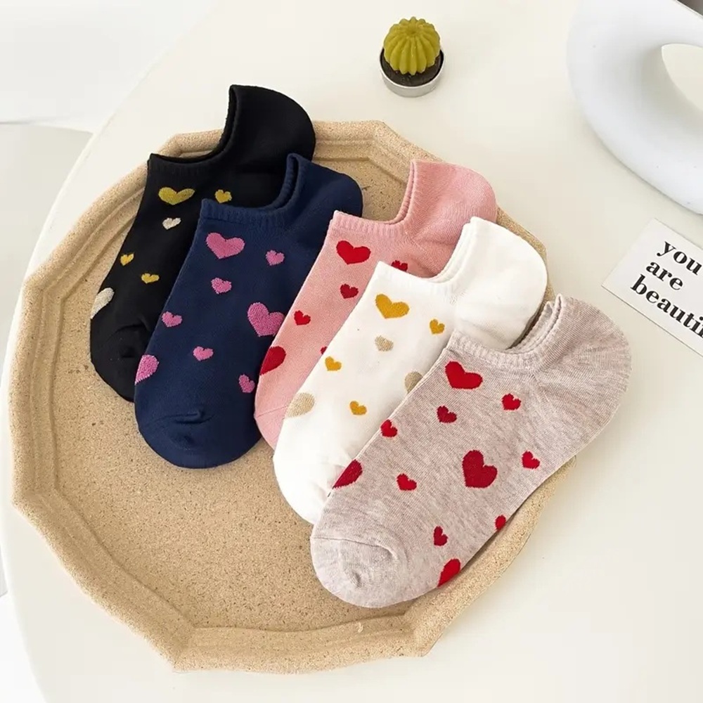 Navy and Red Heart Socks on Feet with Casual Sneakers